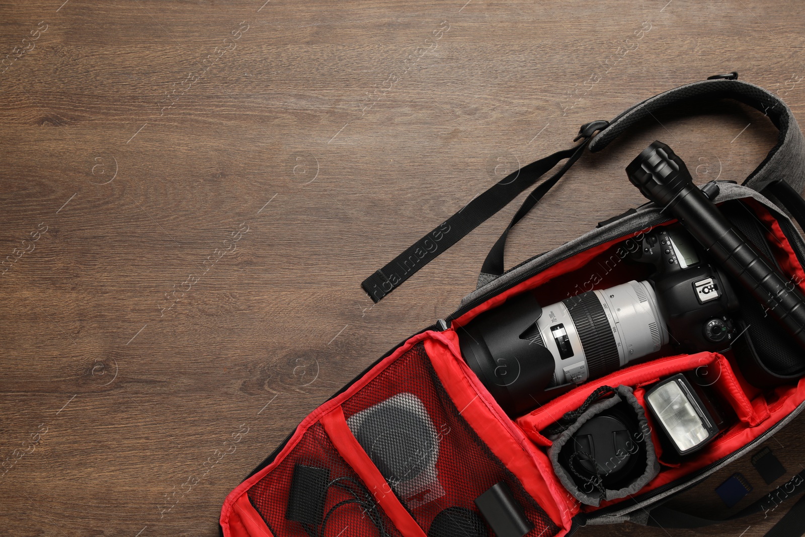 Photo of Photographer's equipment on wooden background, flat lay. Space for text