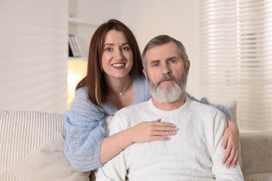 Photo of Family portrait of happy adult daughter and her father at home