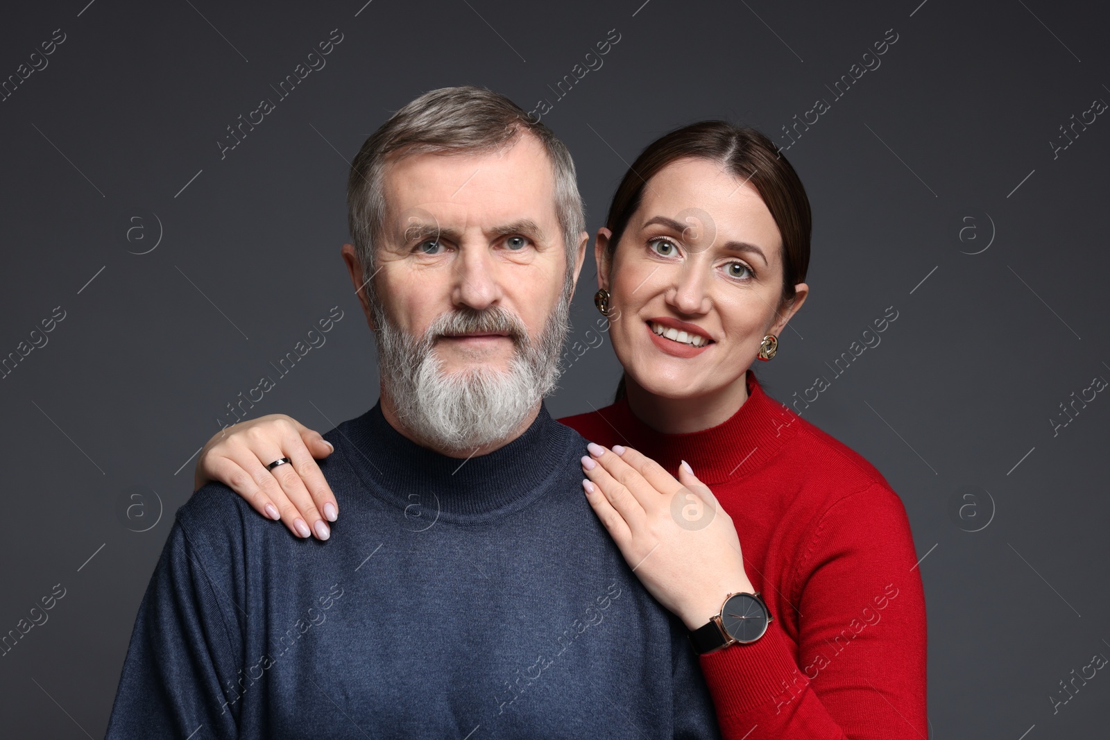 Photo of Family portrait of happy daughter and her father on dark background