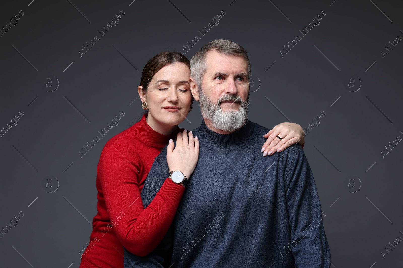 Photo of Daughter and her father on dark background