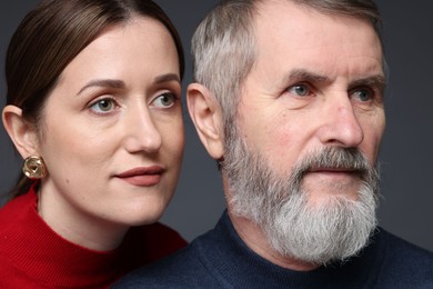 Photo of Daughter and her father on dark background, closeup