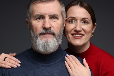 Family portrait of happy daughter and her father on dark background