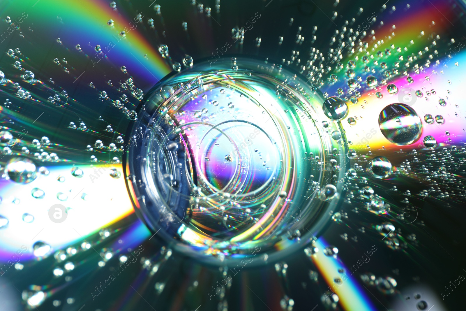 Photo of Compact discs with drops as background, closeup