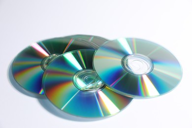 Photo of Many shiny compact discs on light background