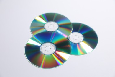 Photo of Many shiny compact discs on light background