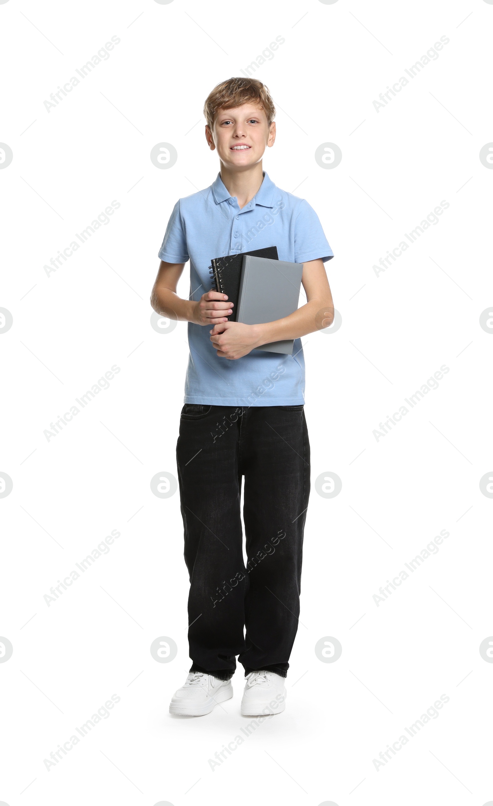 Photo of Full length portrait of teenage boy with books on white background