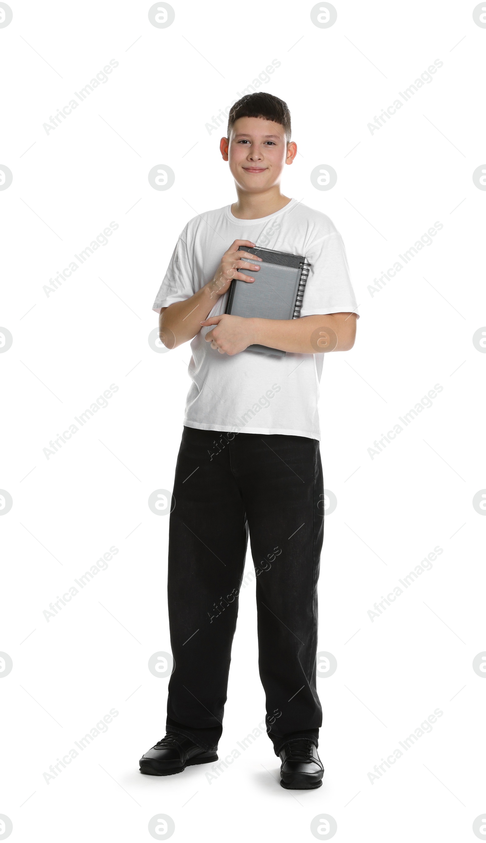 Photo of Full length portrait of teenage boy with books on white background