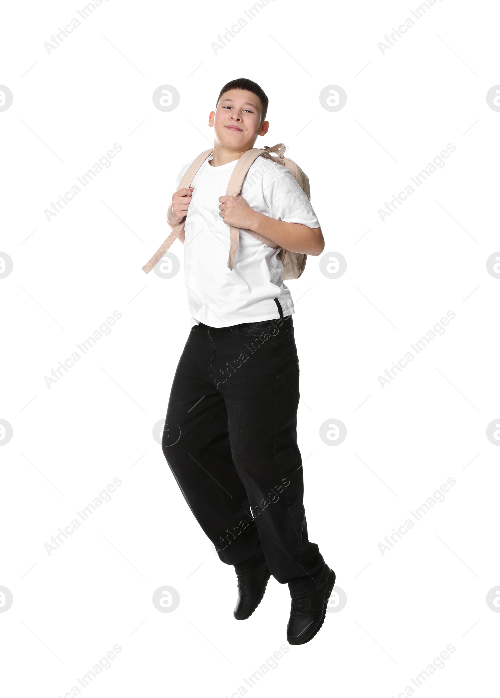 Photo of Teenage boy with backpack jumping on white background