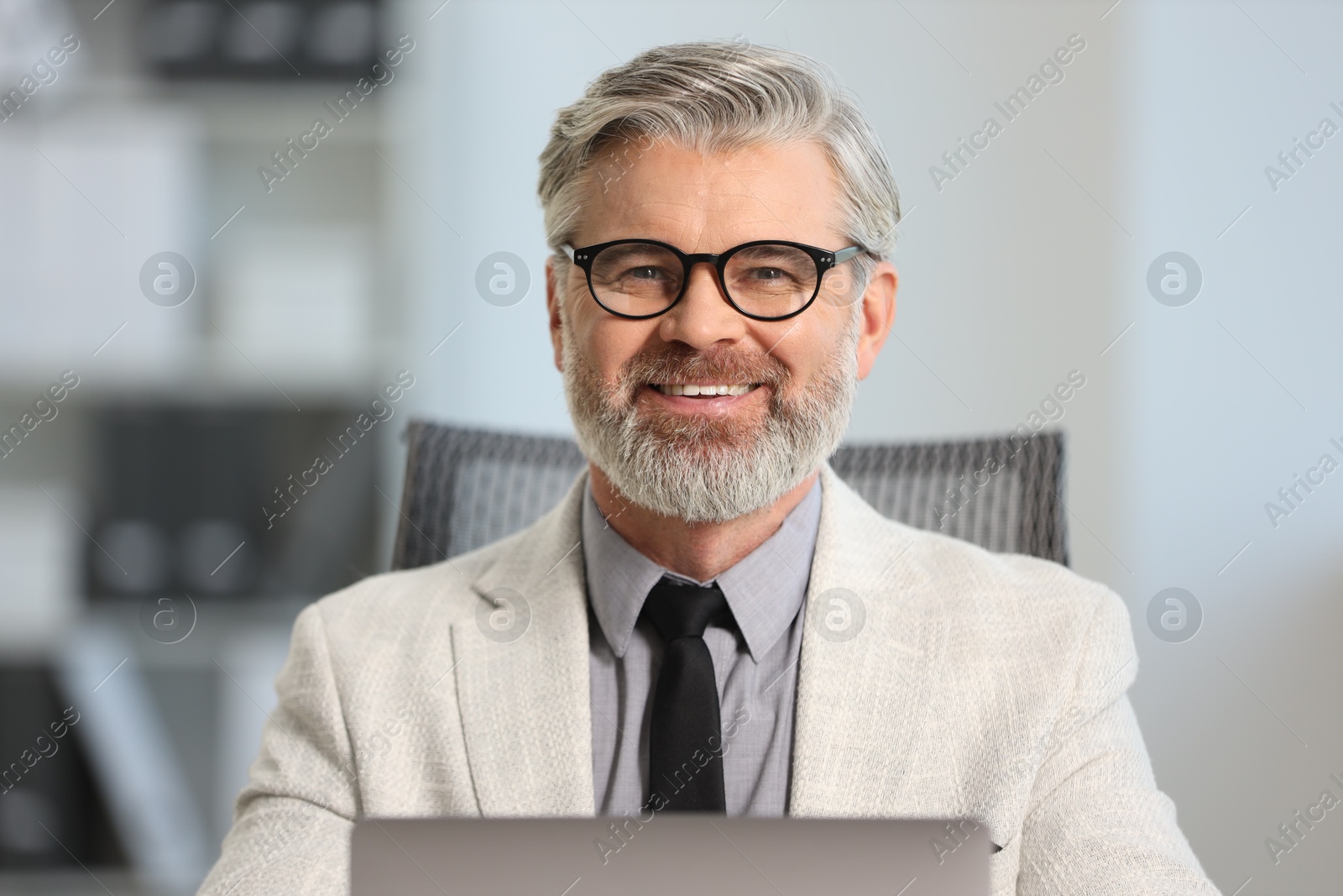 Photo of Portrait of banker with glasses in office