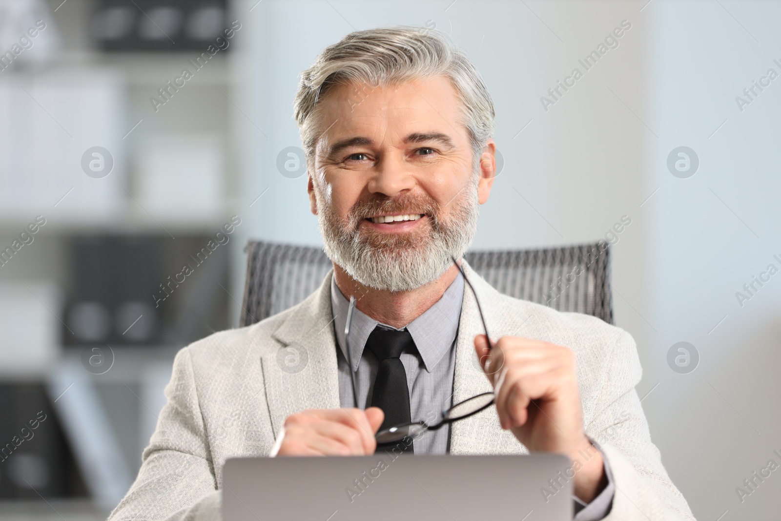 Photo of Portrait of banker with glasses in office