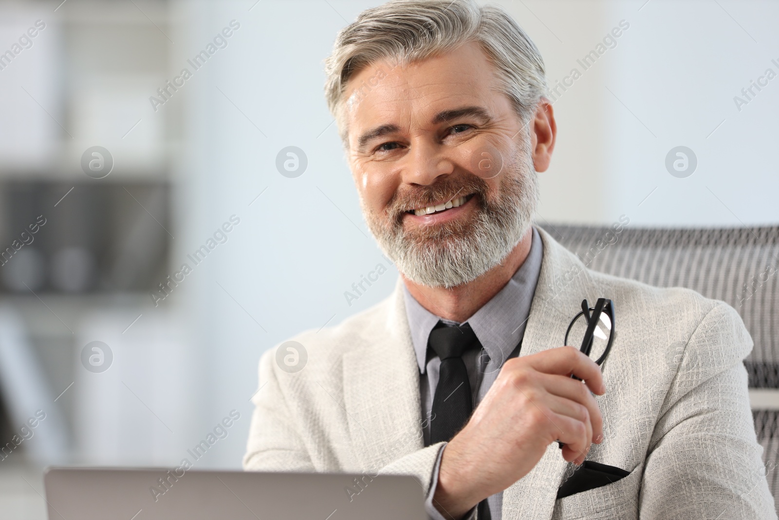 Photo of Portrait of banker with glasses in office, space for text