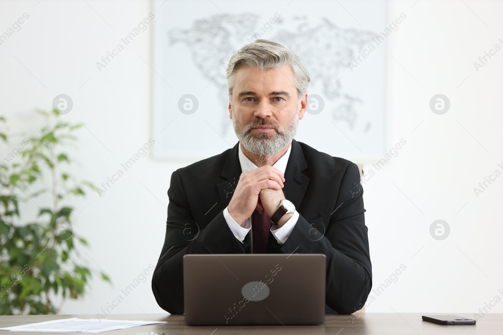 Photo of Portrait of banker at desk in office