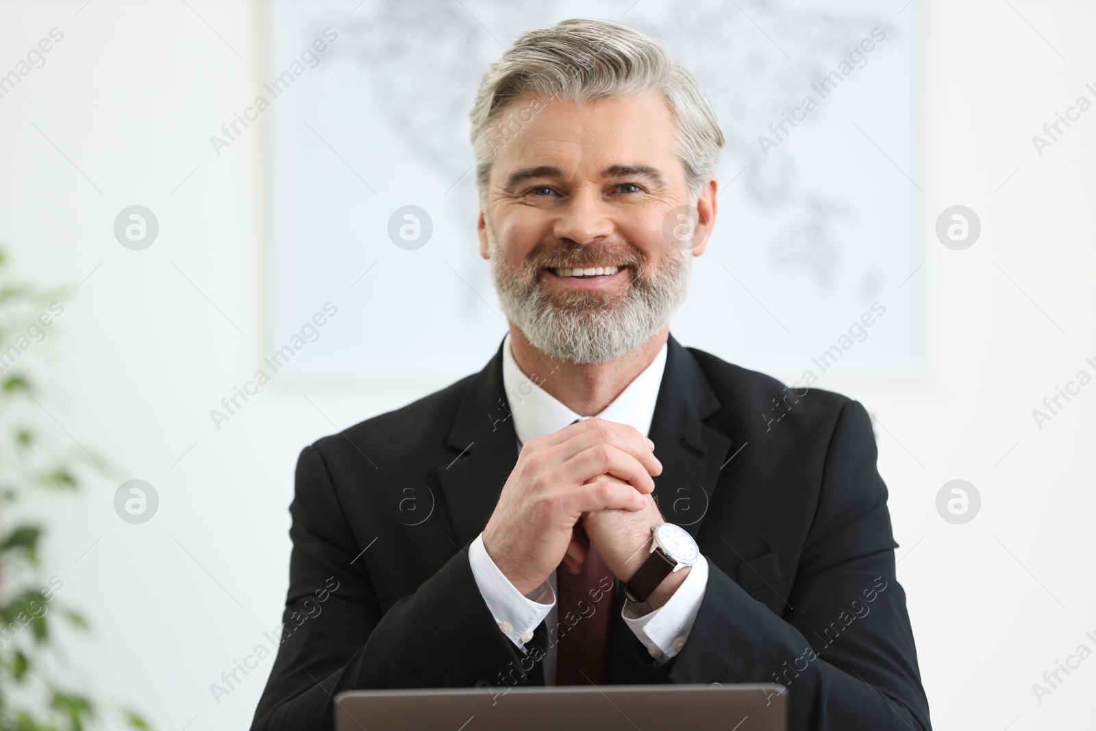 Photo of Portrait of banker in jacket at workplace