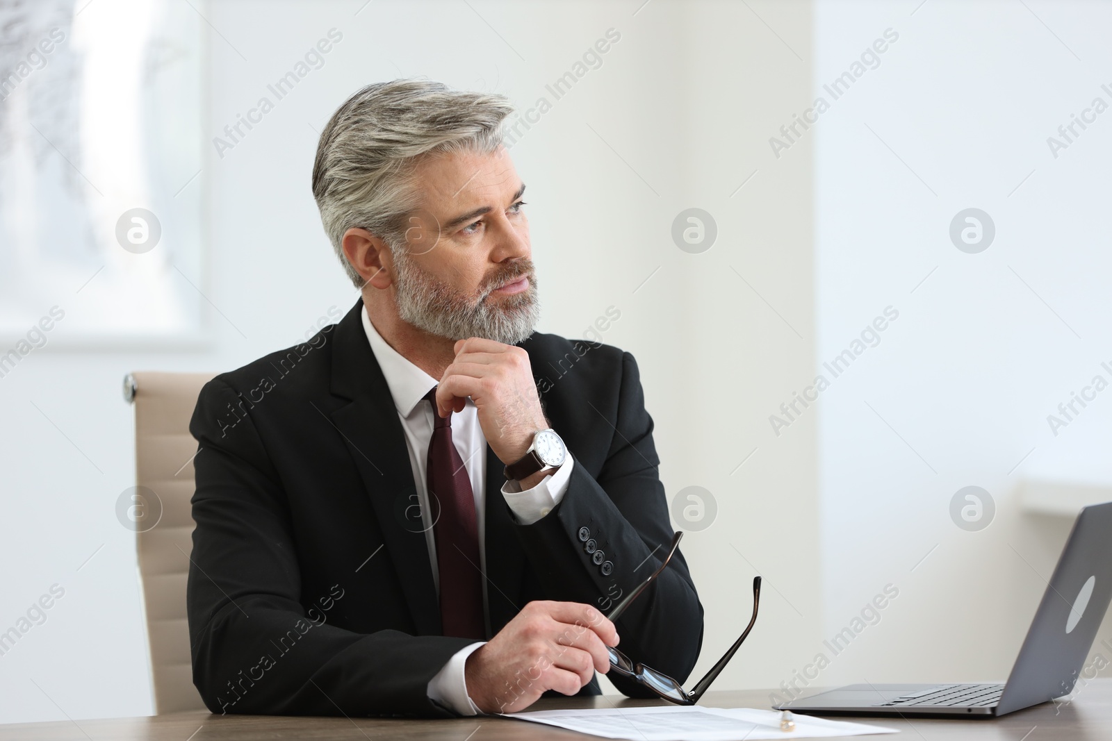 Photo of Banker with glasses at desk in office