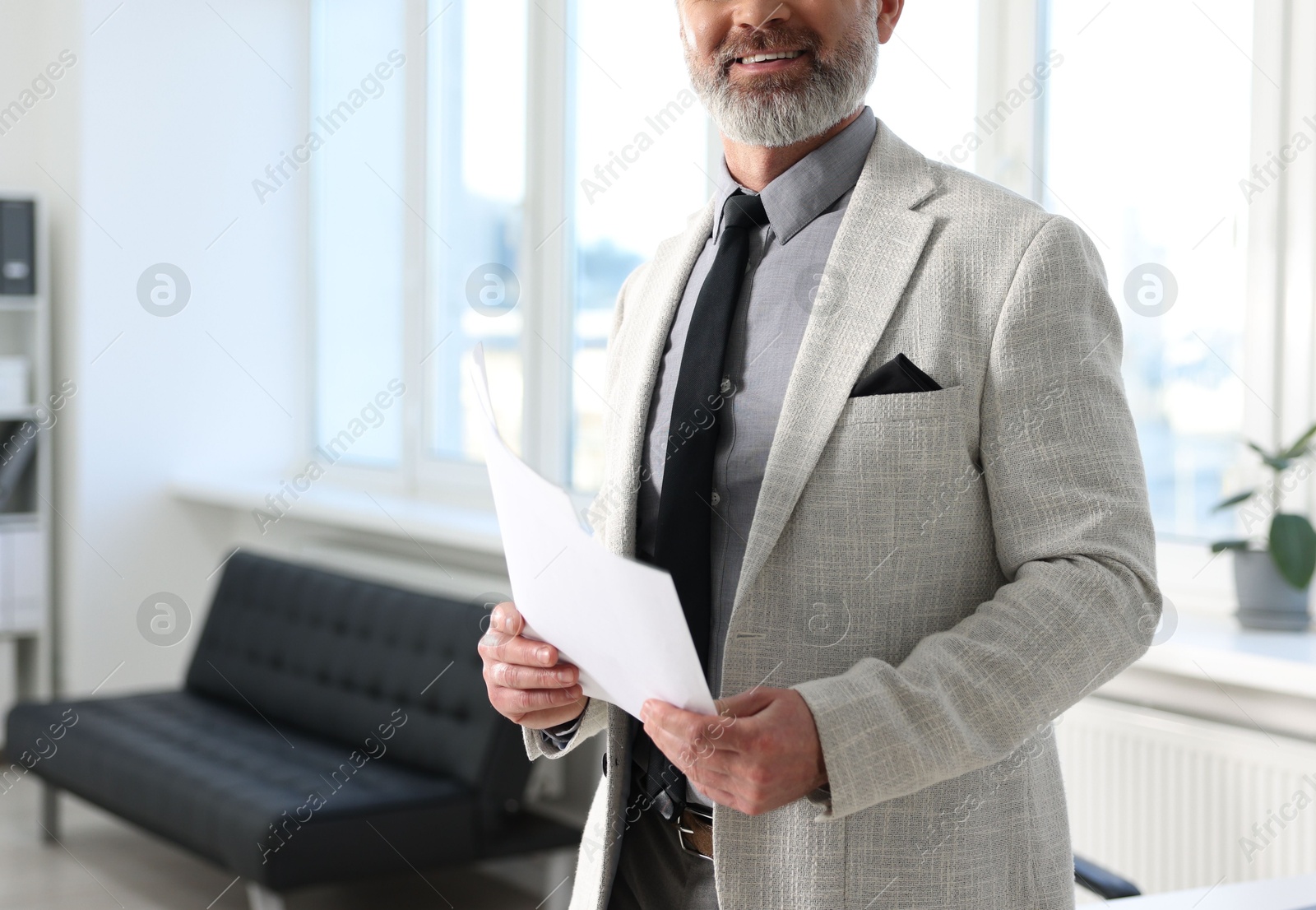 Photo of Banker with documents in office, closeup. Space for text