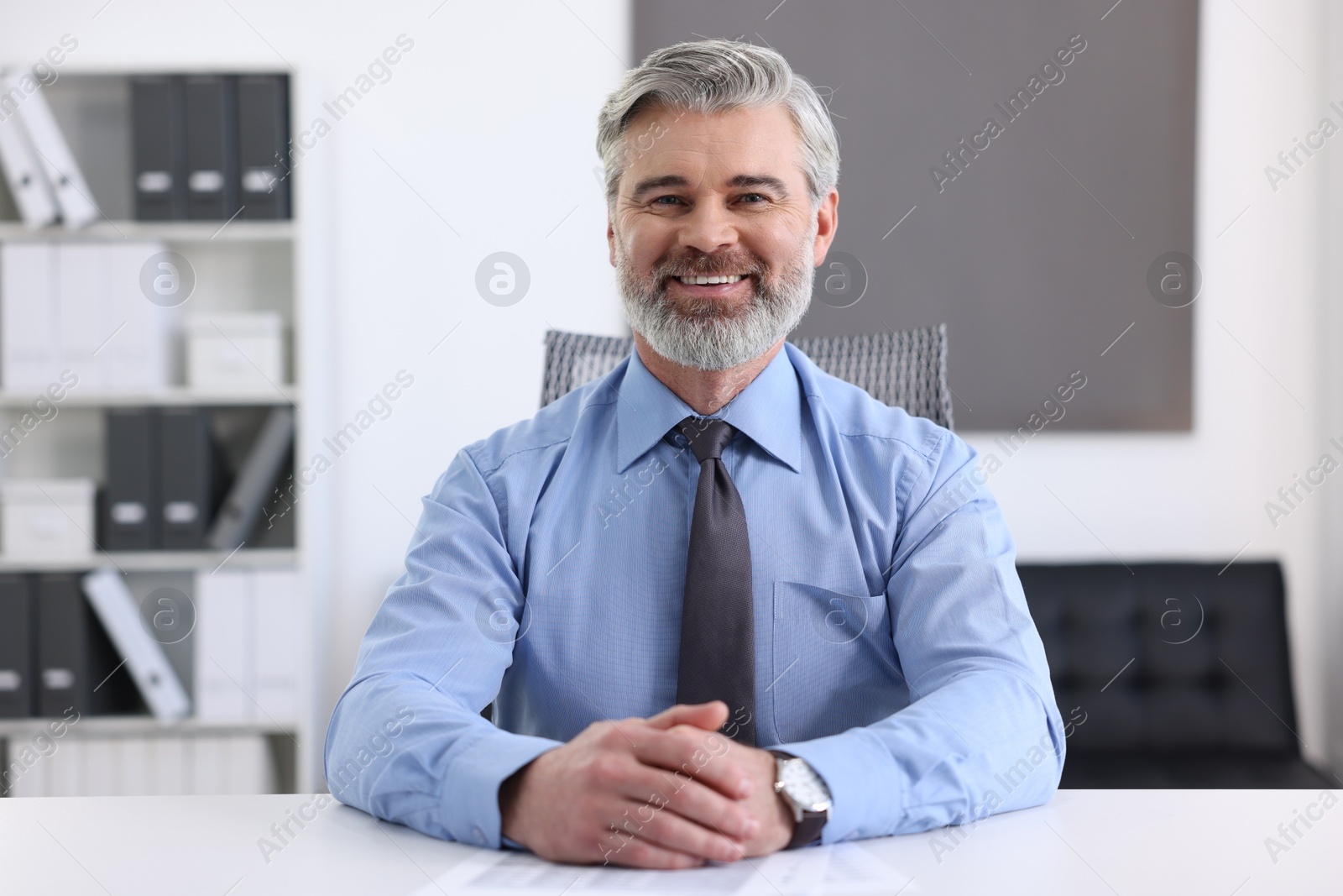 Photo of Portrait of banker at desk in office