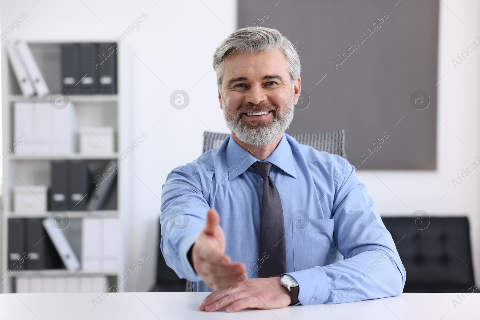 Photo of Portrait of banker at desk in office