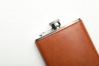 Photo of One hip flask on white table, top view. Space for text