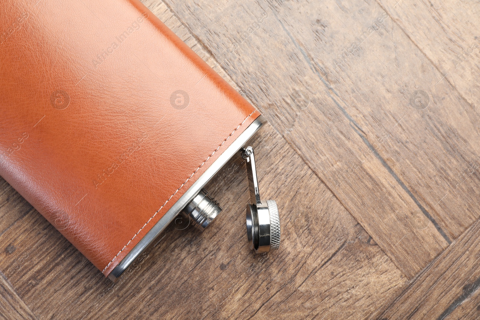 Photo of One hip flask on wooden table, top view. Space for text