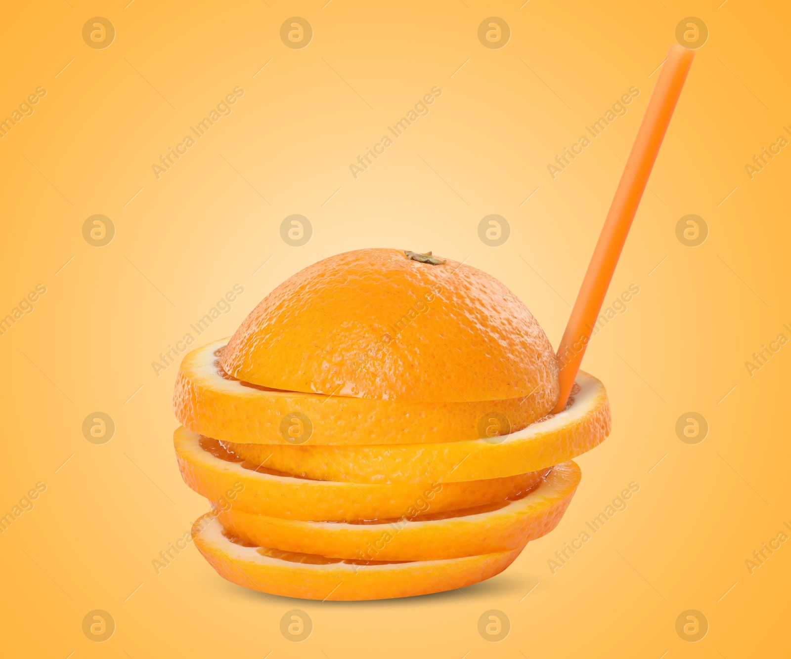 Image of Drinking straw in sliced orange on golden background. Organic juice or freshly made smoothie concept