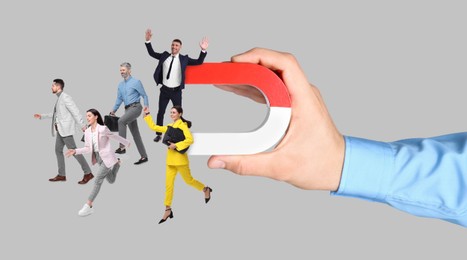 Image of Man with horseshoe magnet in his hand attracting business people on grey background, closeup