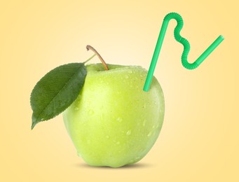 Image of Ripe green apple with drinking straw on yellow background. Organic juice or freshly made smoothie concept