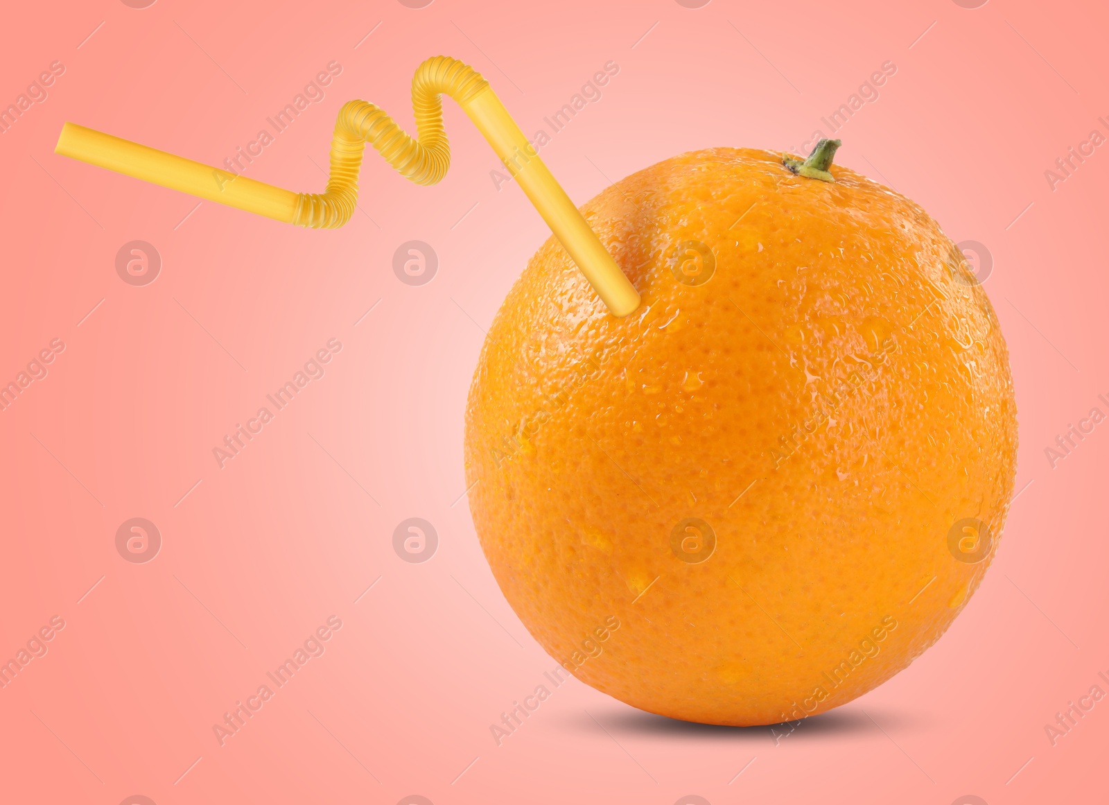 Image of Ripe orange with drinking straw on pink background. Organic juice or freshly made smoothie concept