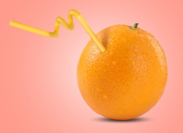 Image of Ripe orange with drinking straw on pink background. Organic juice or freshly made smoothie concept