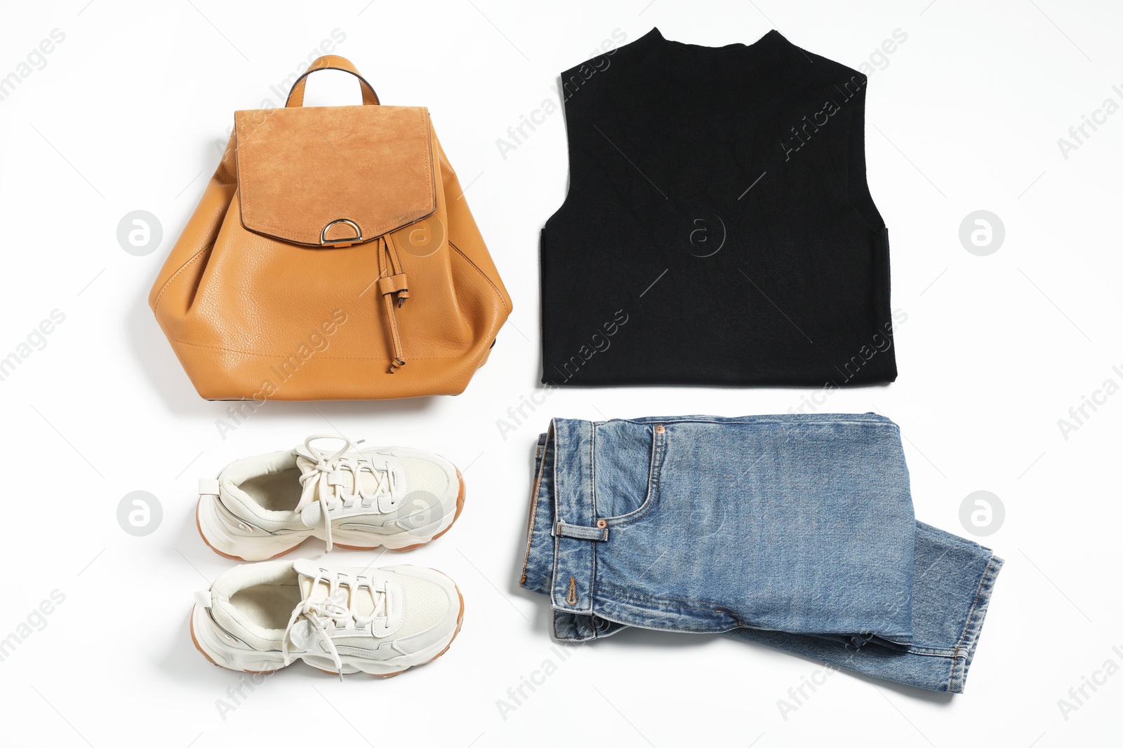 Photo of Stylish outfit with backpack on white background, flat lay