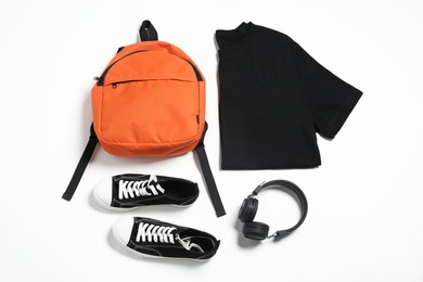 Photo of Stylish outfit with backpack on white background, flat lay