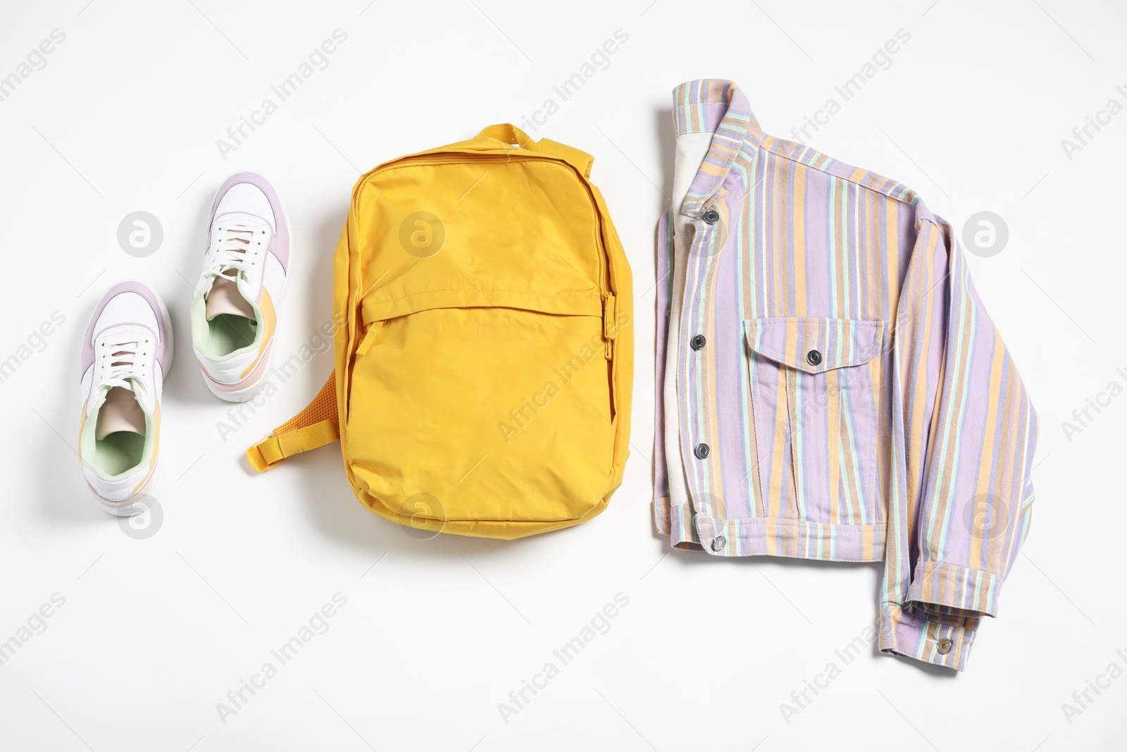 Photo of Stylish outfit with backpack on white background, flat lay