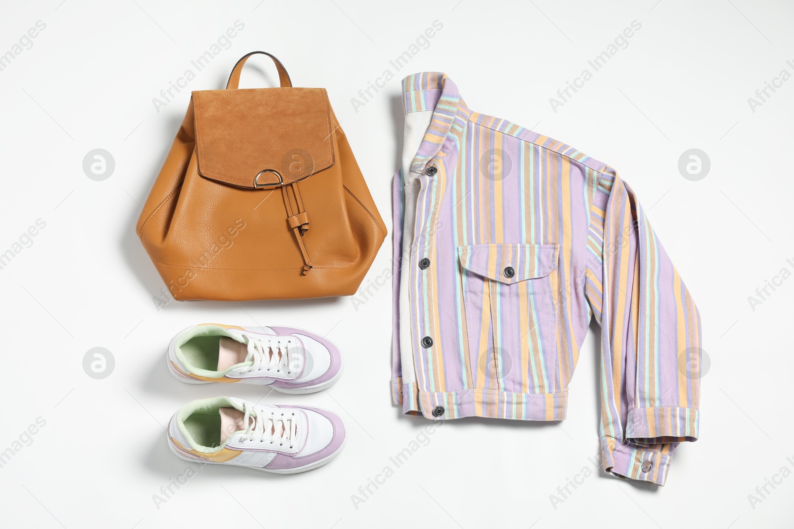 Photo of Stylish outfit with backpack on white background, flat lay