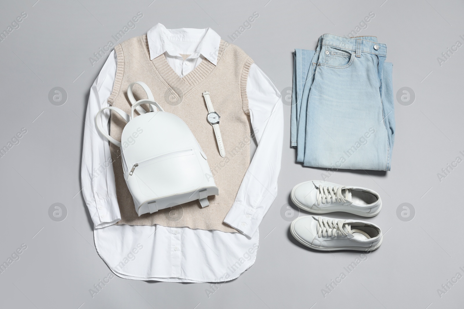 Photo of Stylish outfit with backpack on light grey background, flat lay