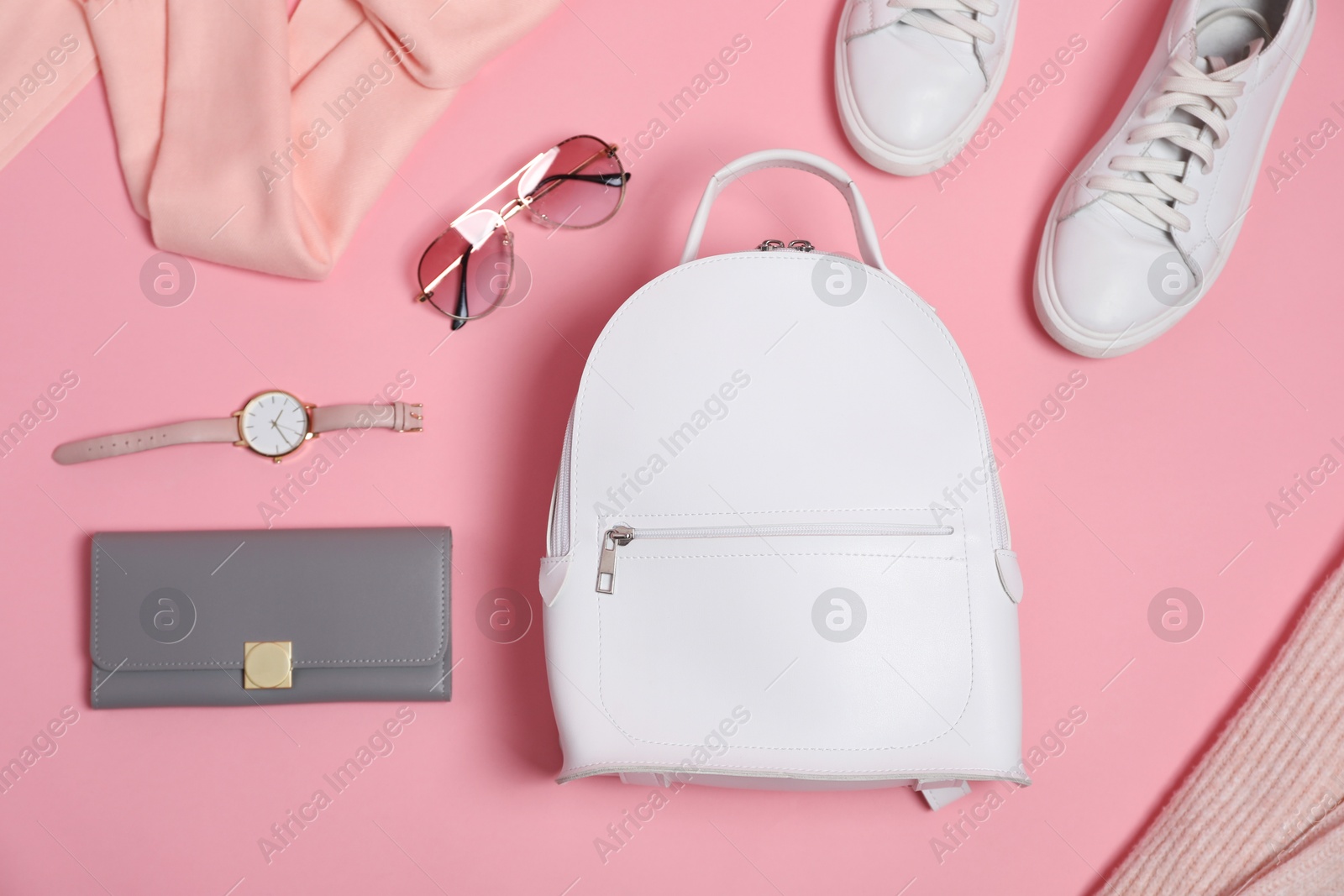 Photo of Stylish accessories on pink background, flat lay