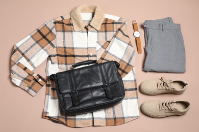 Photo of Stylish outfit with briefcase on brown background, flat lay