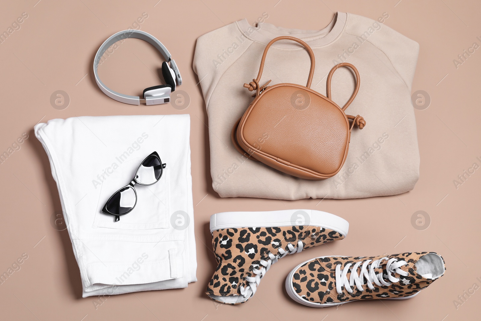 Photo of Stylish outfit with bag on brown background, flat lay