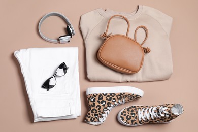 Photo of Stylish outfit with bag on brown background, flat lay