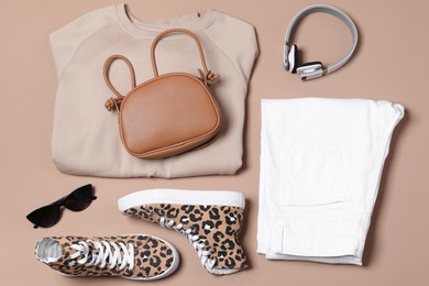 Photo of Stylish outfit with bag on brown background, flat lay