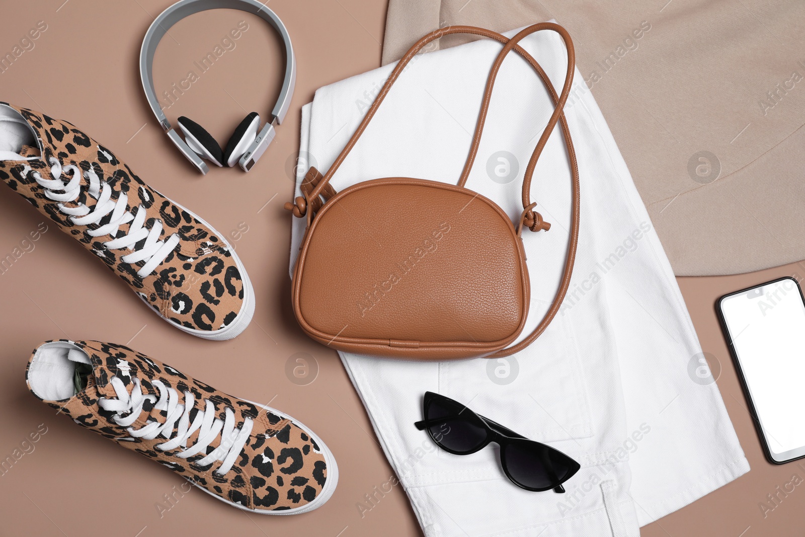 Photo of Stylish outfit with bag on brown background, flat lay