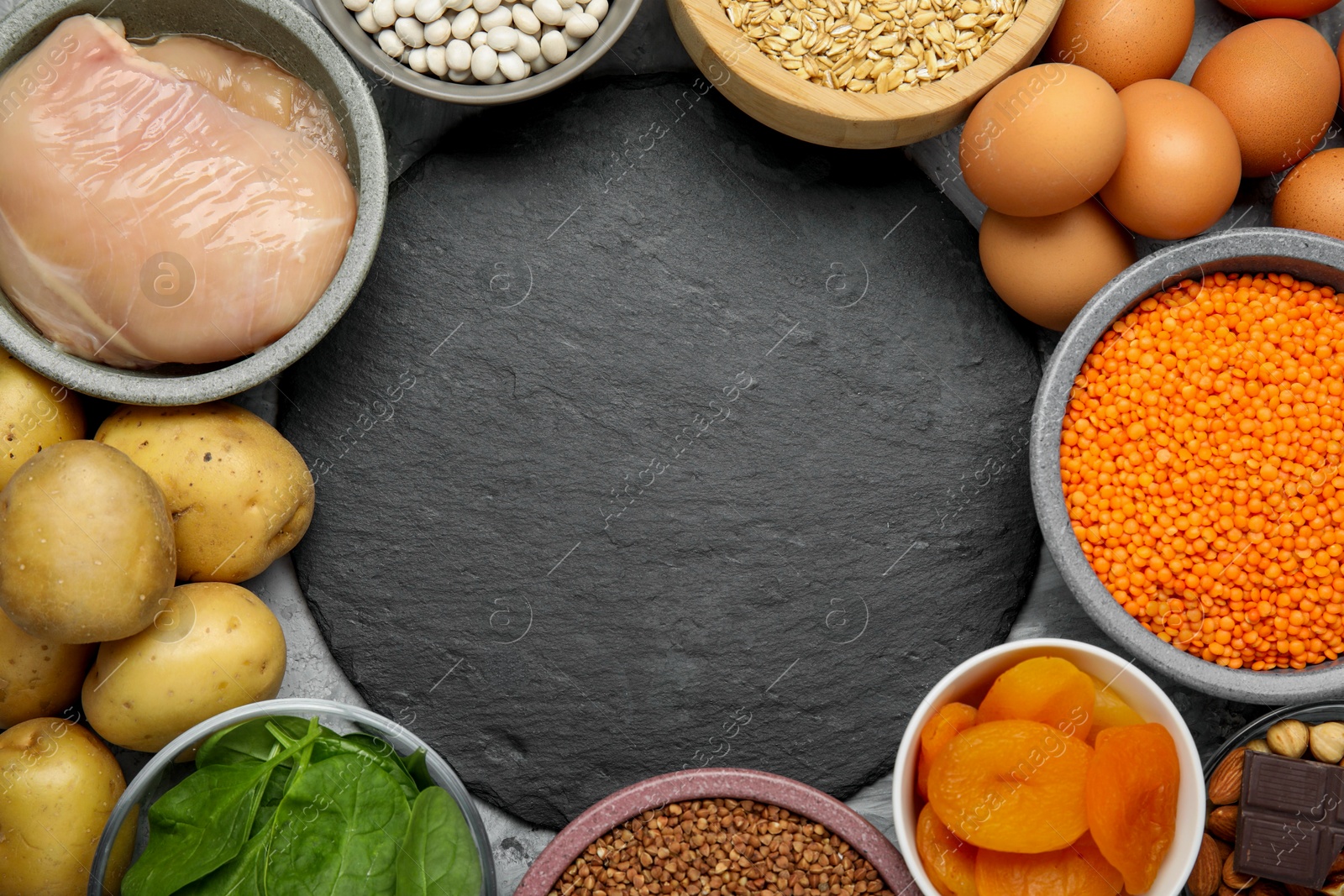 Photo of Diet plan for anemia. Different products rich in iron and slate board on grey table, flat lay. Space for text