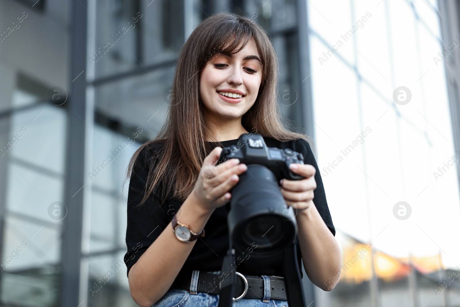 Photo of Professional photographer with digital camera near building outdoors