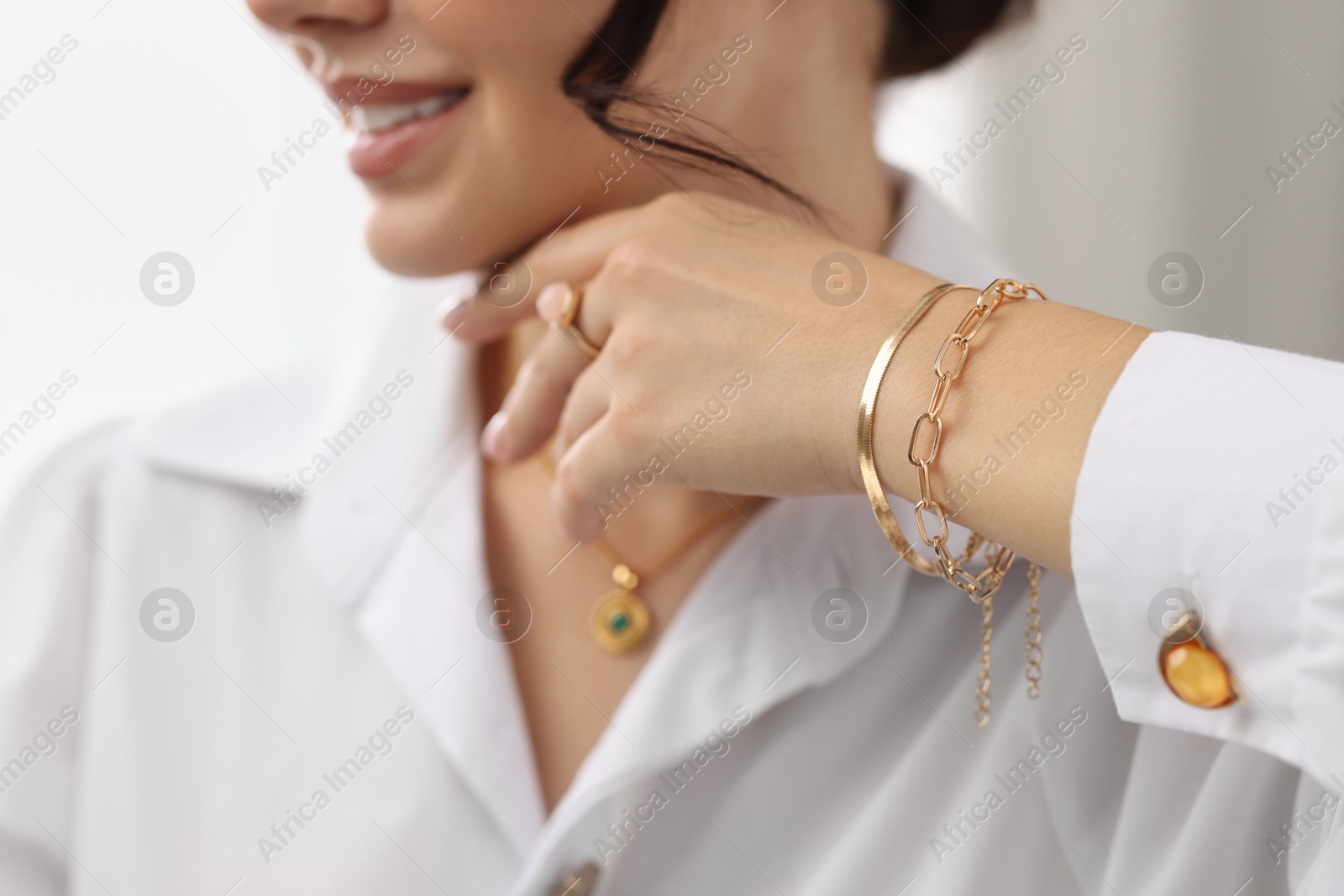 Photo of Young woman wearing elegant jewelry indoors, closeup