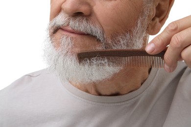 Photo of Senior man combing beard on white background, closeup