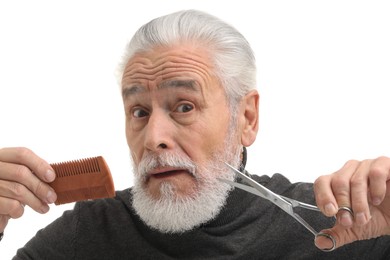 Photo of Bearded senior man holding comb and scissors on white background