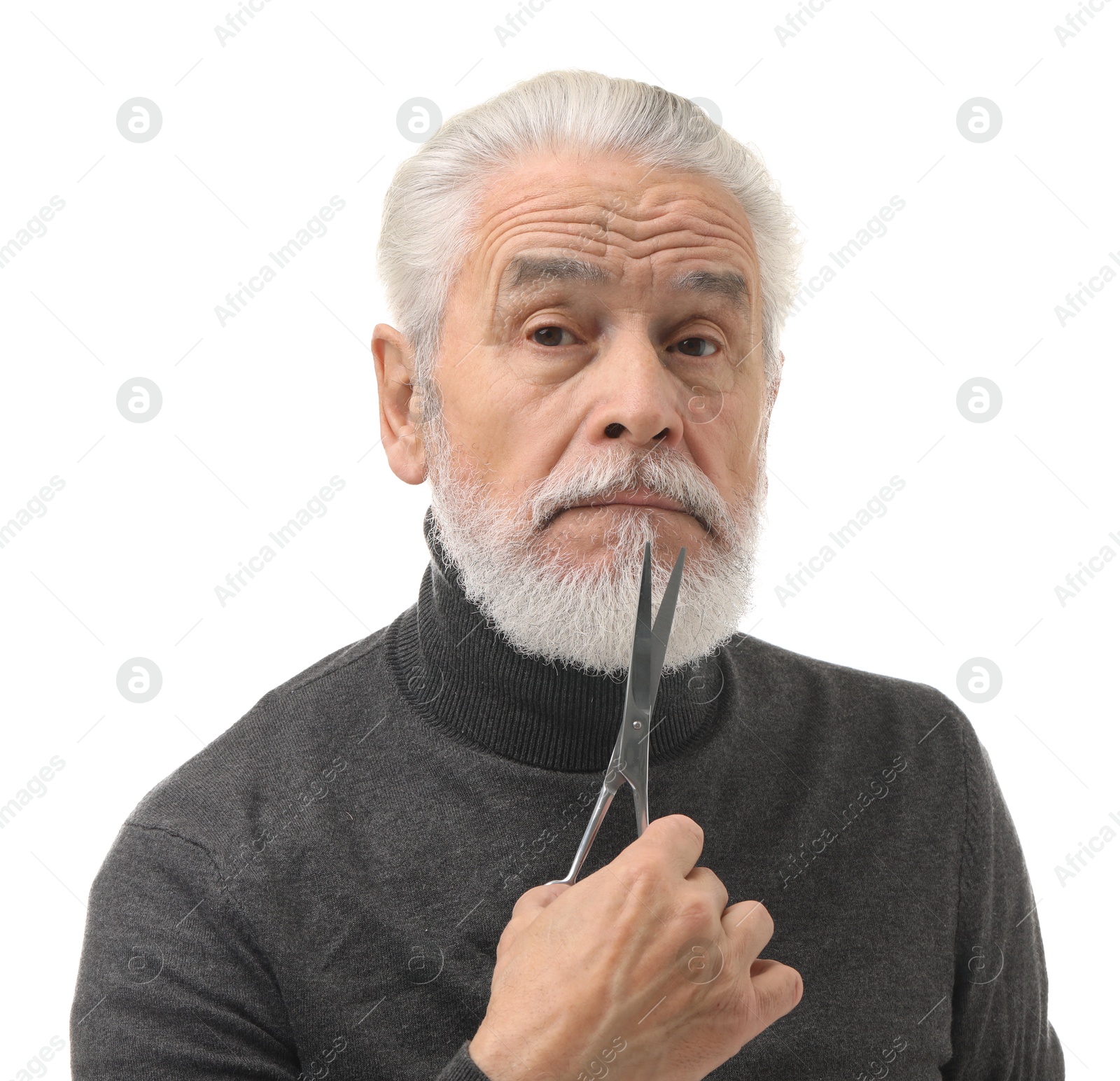 Photo of Bearded senior man holding scissors on white background