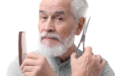 Photo of Bearded senior man with comb and scissors on white background