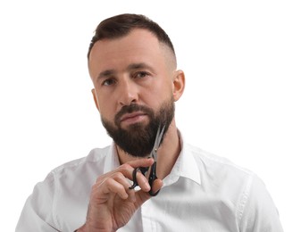 Photo of Man trimming beard with scissors on white background