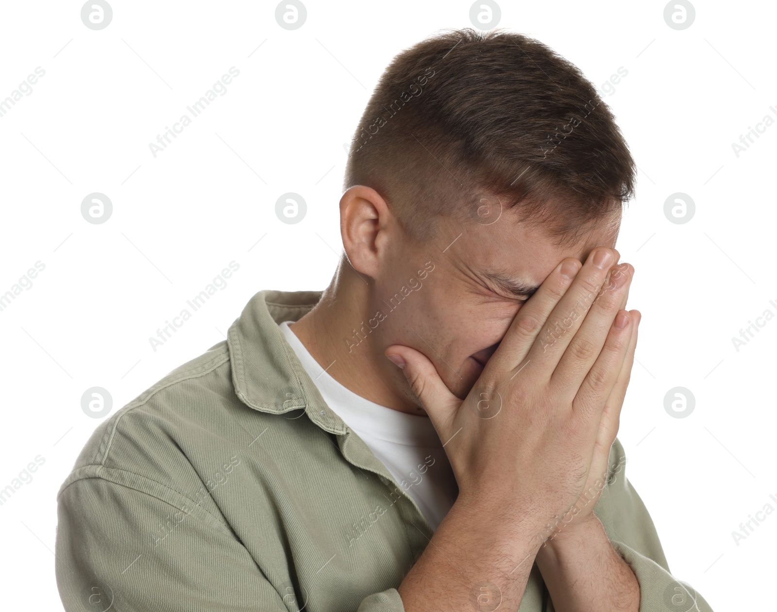 Photo of Distressed young man crying on white background