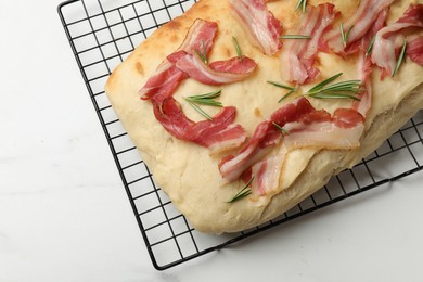 Photo of Delicious focaccia bread with bacon and rosemary on white table, top view