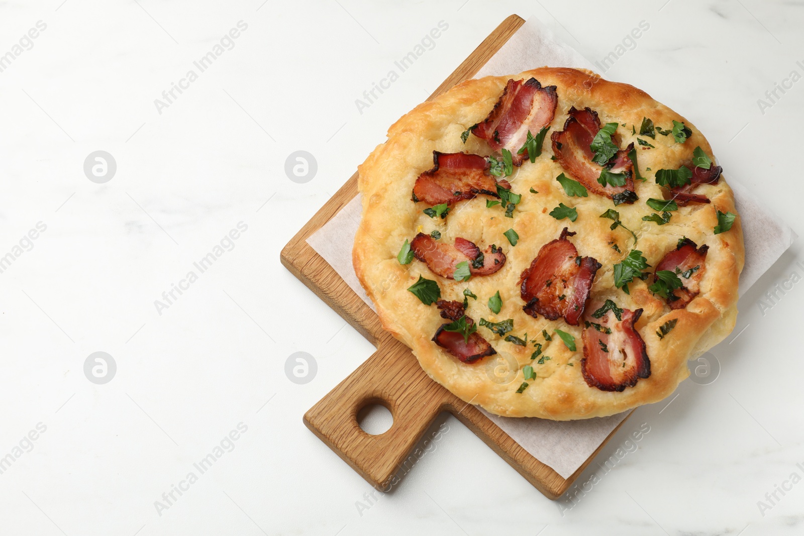 Photo of Delicious focaccia bread with bacon and parsley on white table, top view